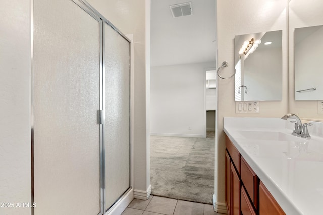 bathroom featuring vanity, baseboards, visible vents, a shower stall, and tile patterned floors