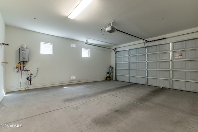 garage with a garage door opener, tankless water heater, and baseboards