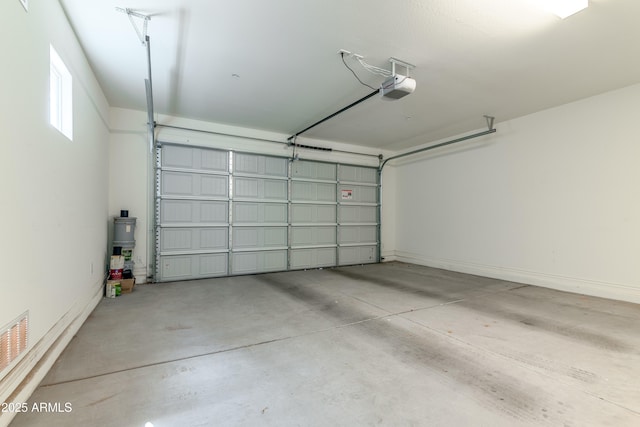 garage featuring a garage door opener and visible vents