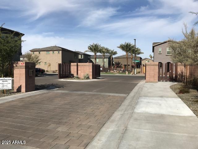 view of road featuring a gate, a residential view, and a gated entry