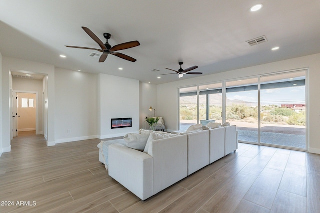 3909 S Veronica Ln, Gold Canyon, AZ 85118 - living room featuring ceiling fan, visible vents, baseboards, and light wood-style flooring