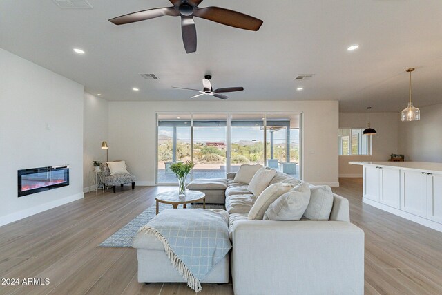 3909 S Veronica Ln, Gold Canyon, AZ 85118 - living area with light wood-style flooring, ceiling fan, baseboards, and visible vents