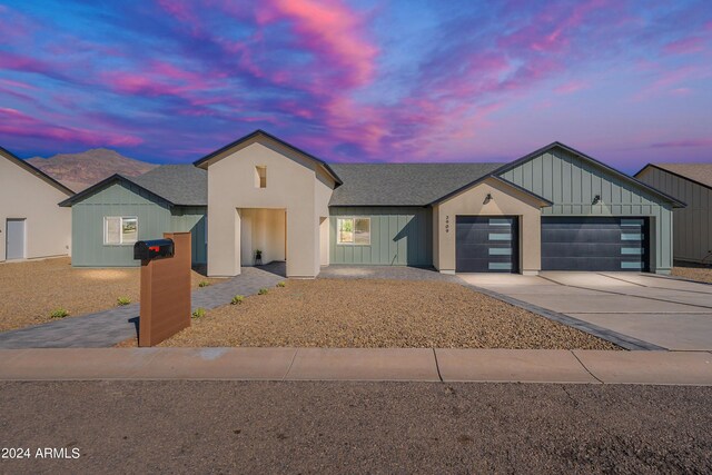 3909 S Veronica Ln, Gold Canyon, AZ 85118 - view of front of property with an attached garage, roof with shingles, board and batten siding, and driveway