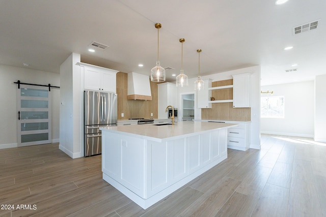 3909 S Veronica Ln, Gold Canyon, AZ 85118 - kitchen with freestanding refrigerator, open shelves, visible vents, a sink, and premium range hood