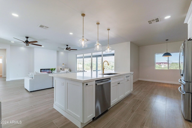 3909 S Veronica Ln, Gold Canyon, AZ 85118 - kitchen with ceiling fan, visible vents, appliances with stainless steel finishes, a sink, and baseboards