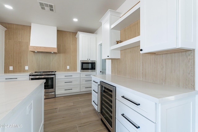 3909 S Veronica Ln, Gold Canyon, AZ 85118 - kitchen featuring custom exhaust hood, visible vents, open shelves, appliances with stainless steel finishes, and wine cooler