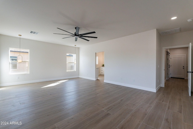 3909 S Veronica Ln, Gold Canyon, AZ 85118 - spare room featuring visible vents, ceiling fan, wood finished floors, and baseboards