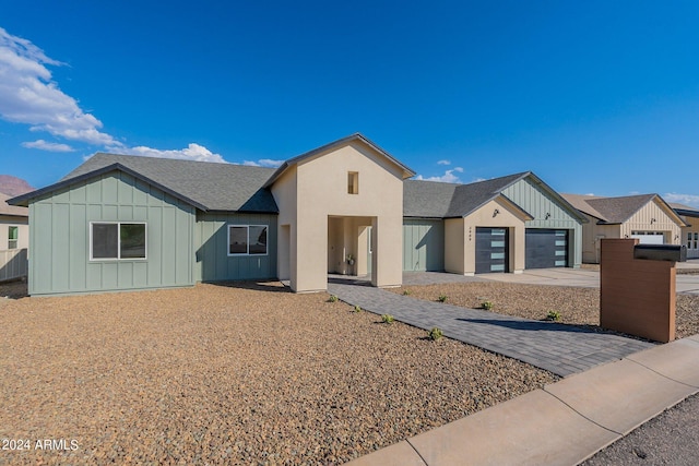 3909 S Veronica Ln, Gold Canyon, AZ 85118 - ranch-style house featuring concrete driveway, roof with shingles, board and batten siding, and an attached garage