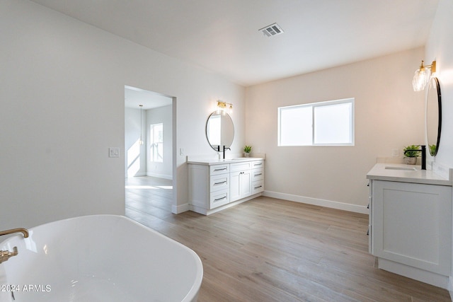3909 S Veronica Ln, Gold Canyon, AZ 85118 - full bath featuring a wealth of natural light, a freestanding tub, visible vents, and wood finished floors