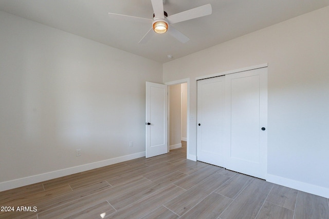 3909 S Veronica Ln, Gold Canyon, AZ 85118 - unfurnished bedroom featuring light wood-style floors, a closet, baseboards, and a ceiling fan