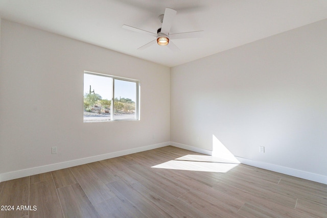 3909 S Veronica Ln, Gold Canyon, AZ 85118 - empty room featuring light wood-type flooring, ceiling fan, and baseboards
