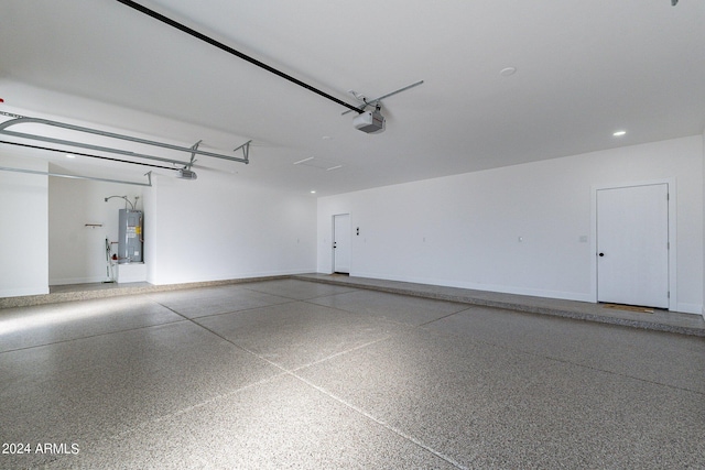 3909 S Veronica Ln, Gold Canyon, AZ 85118 - garage featuring electric water heater, baseboards, and a garage door opener