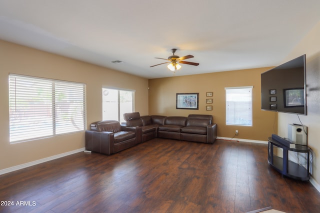 living room featuring ceiling fan and dark hardwood / wood-style flooring