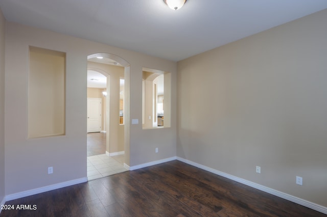 spare room with wood-type flooring