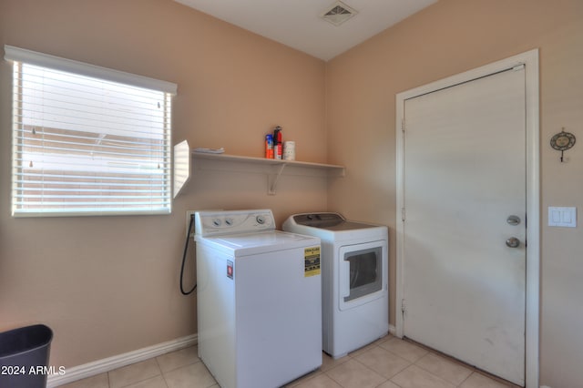 laundry room featuring independent washer and dryer and light tile patterned floors