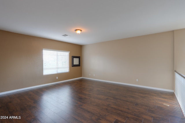 empty room with dark hardwood / wood-style floors