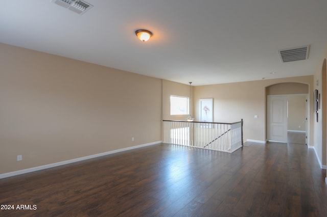 spare room with dark hardwood / wood-style floors