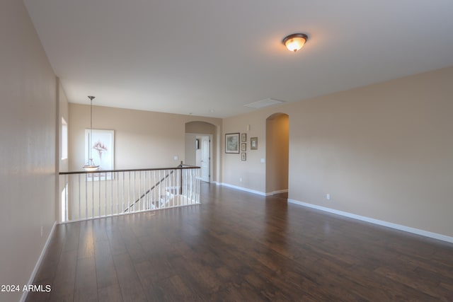 unfurnished room with dark hardwood / wood-style flooring