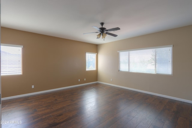 unfurnished room featuring ceiling fan and dark hardwood / wood-style flooring