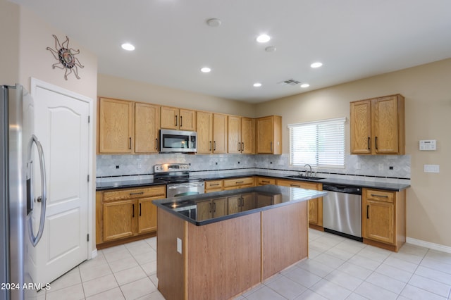 kitchen with decorative backsplash, light tile patterned floors, stainless steel appliances, a center island, and sink