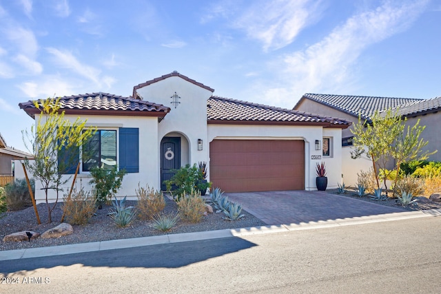 mediterranean / spanish home with a garage