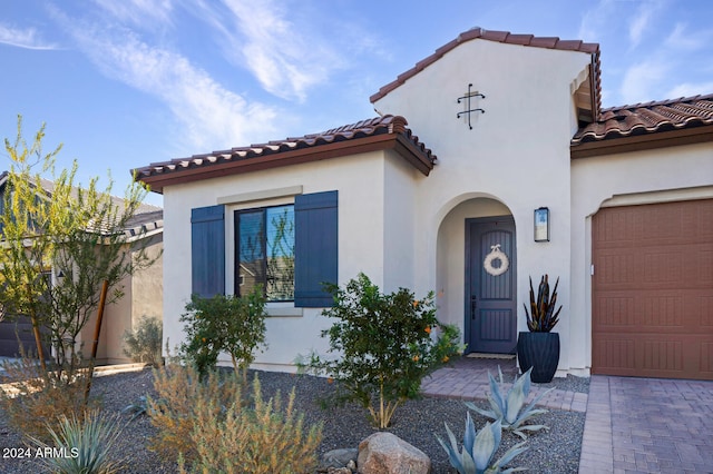 mediterranean / spanish home with a garage