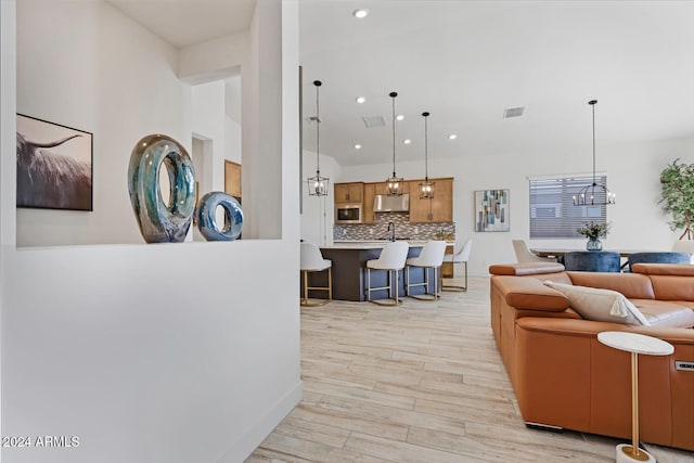 living room featuring light hardwood / wood-style flooring and a chandelier