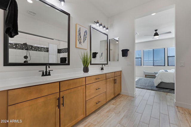 bathroom featuring a shower, vanity, hardwood / wood-style flooring, and ceiling fan