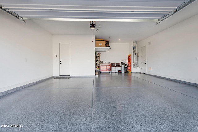 garage with a garage door opener and gas water heater