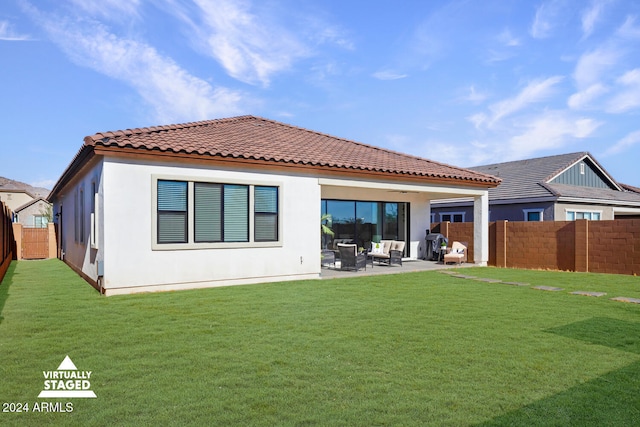 rear view of property featuring a lawn and a patio