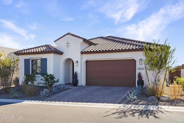 mediterranean / spanish home with a garage