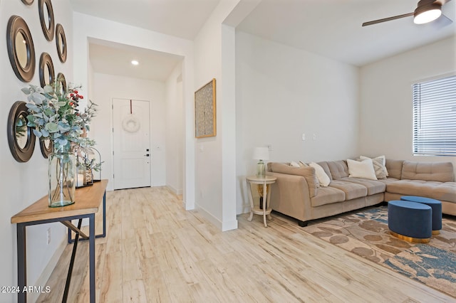 living room featuring ceiling fan and light wood-type flooring