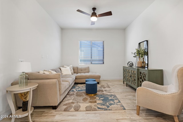 living room featuring light wood-type flooring and ceiling fan