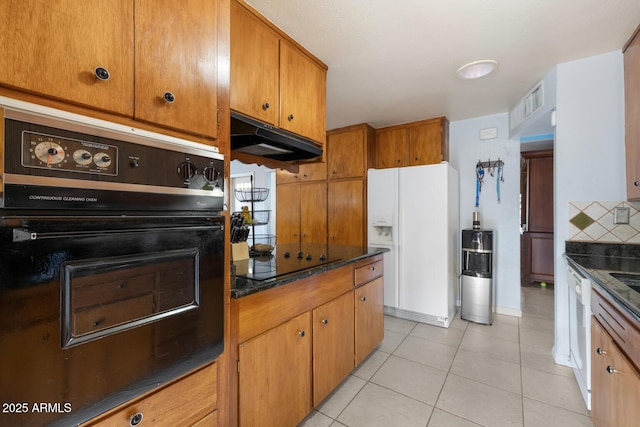 kitchen featuring tasteful backsplash, light tile patterned floors, and black appliances