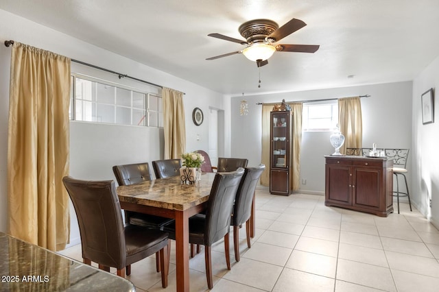 tiled dining area featuring ceiling fan