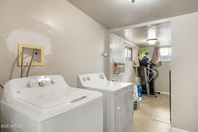 washroom featuring light tile patterned flooring and washing machine and clothes dryer