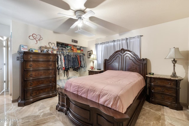 bedroom with ceiling fan and a closet