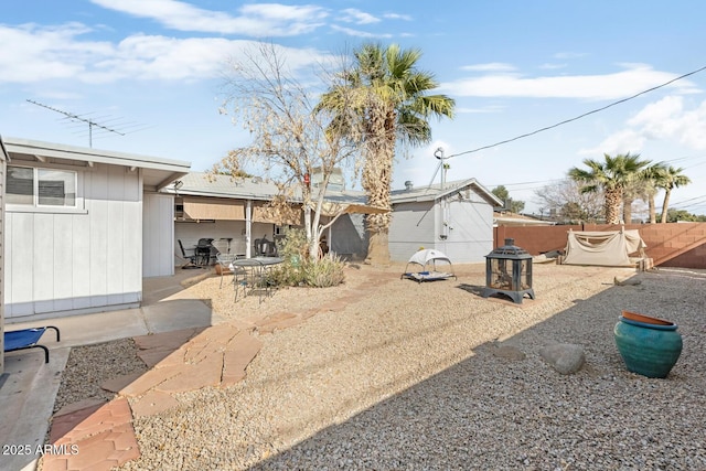 exterior space featuring a patio area and a fire pit