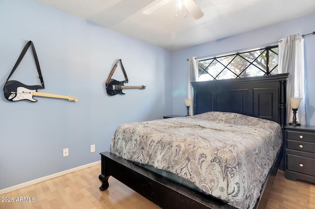 bedroom with light wood-type flooring and ceiling fan