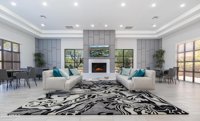 9475 N 115th Pl, Scottsdale, AZ 85259 - living area featuring a raised ceiling, plenty of natural light, recessed lighting, and a fireplace