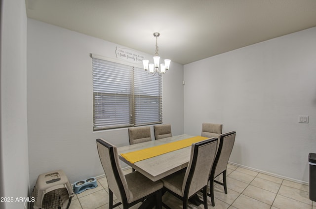 tiled dining area featuring a chandelier