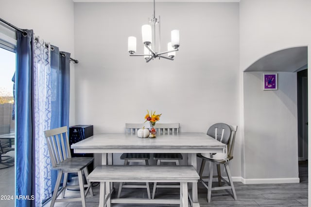 dining room featuring dark wood-type flooring and an inviting chandelier