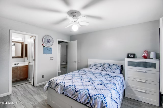 bedroom with sink, ceiling fan, ensuite bathroom, and light hardwood / wood-style floors