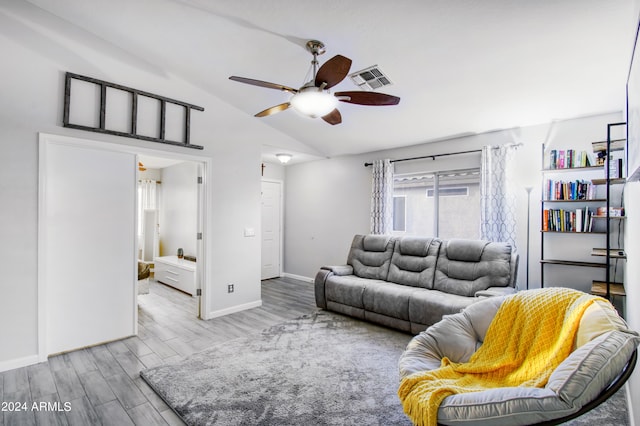 living room with lofted ceiling, light hardwood / wood-style floors, and ceiling fan