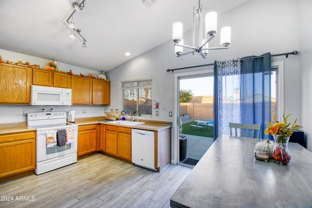 kitchen with high vaulted ceiling, light wood-type flooring, sink, decorative light fixtures, and white appliances