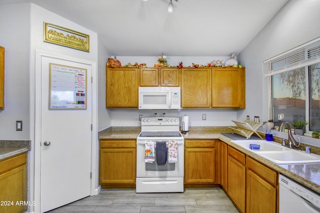 kitchen with white appliances, light hardwood / wood-style flooring, and sink