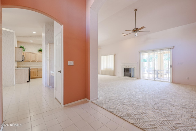 unfurnished living room featuring light carpet and ceiling fan