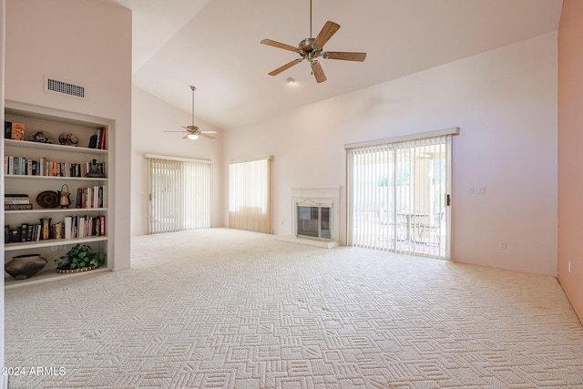 unfurnished living room with ceiling fan, light colored carpet, built in features, and high vaulted ceiling