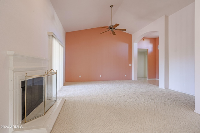 unfurnished living room featuring light colored carpet, high vaulted ceiling, and ceiling fan