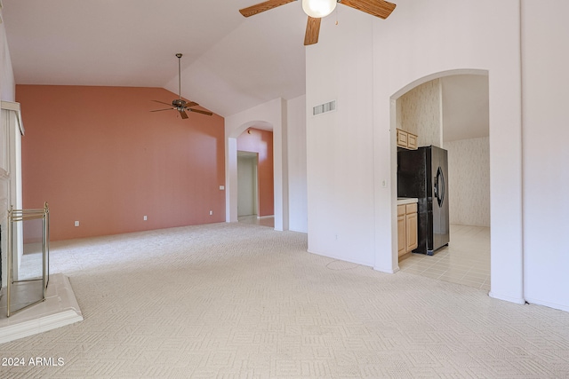 interior space with ceiling fan, light carpet, and high vaulted ceiling